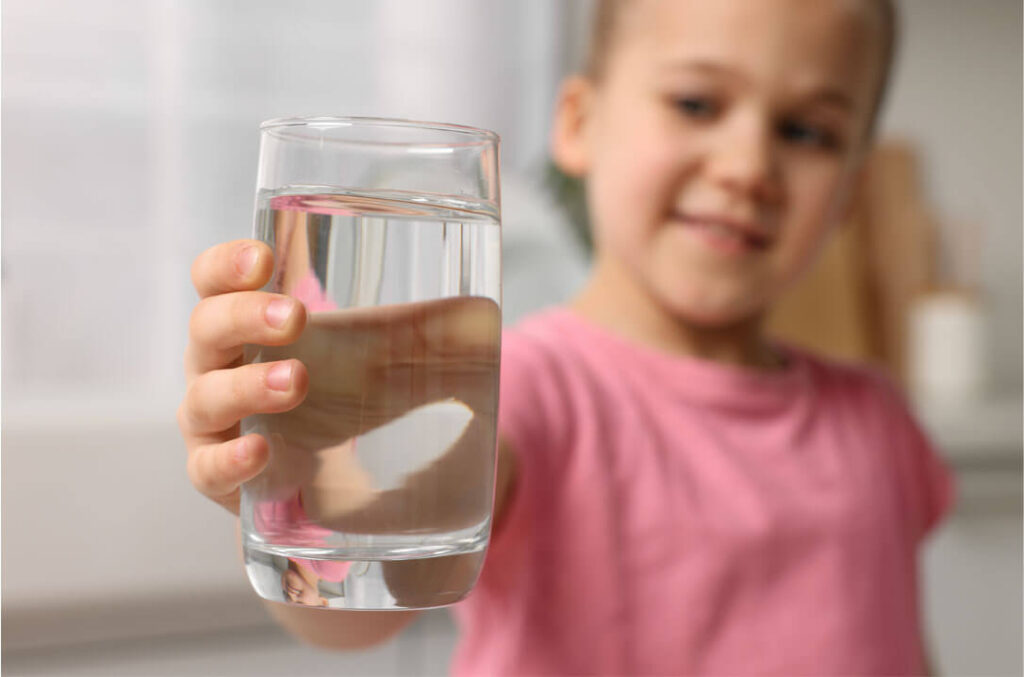 Girl with glass of clean water
