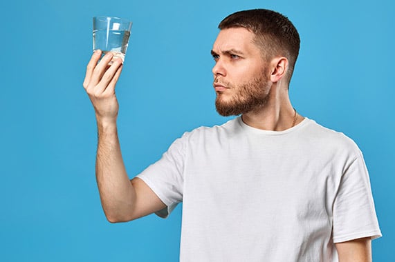 man holding a glass of water
